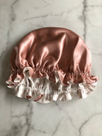 Silky satin hair bonnet on a marble surface