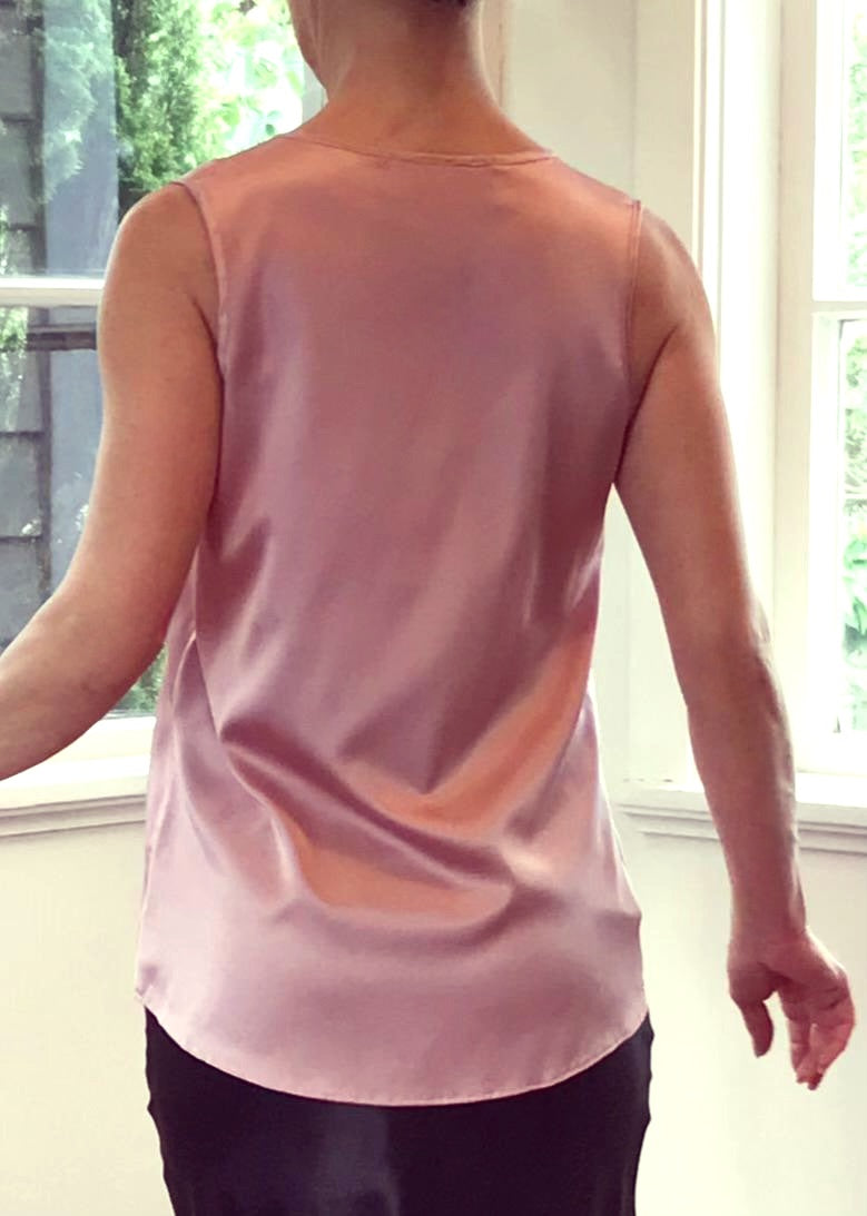Person wearing a silk pink top 